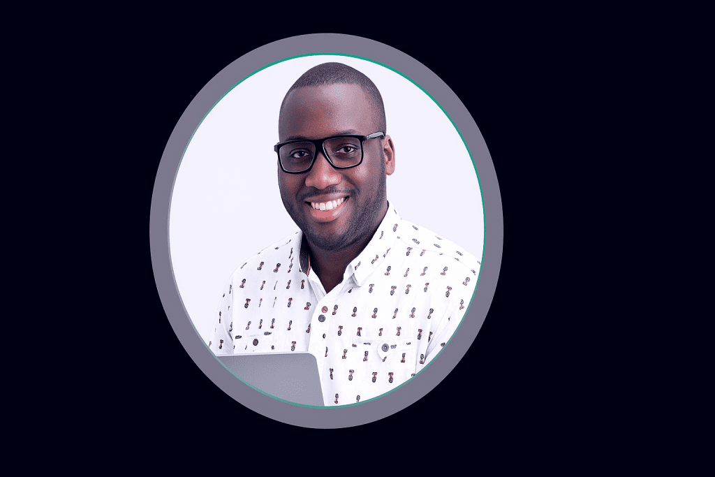 VidBamboo Review – Creator of VidBamboo smiling with laptop, representing the AI tool that turns keywords into YouTube videos.